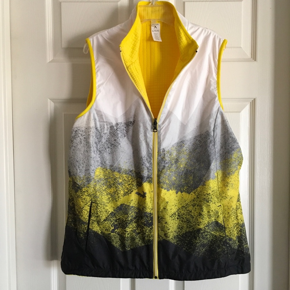 Yellow accented reversible athletic vest with many zippered pockets.